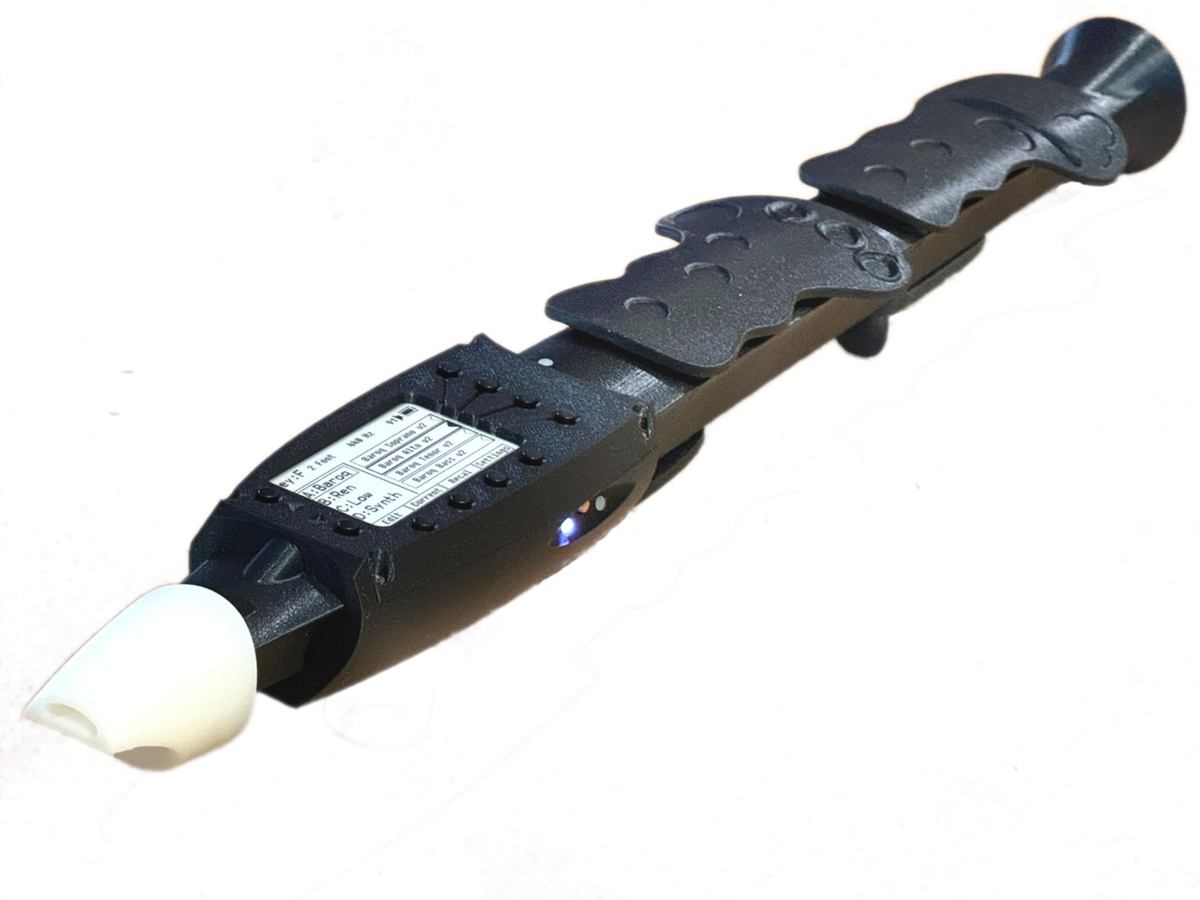 The eCorder: a black electronic alto recorder with a white mouthpiece, sculpted touch-sensitive body, and status LEDs.